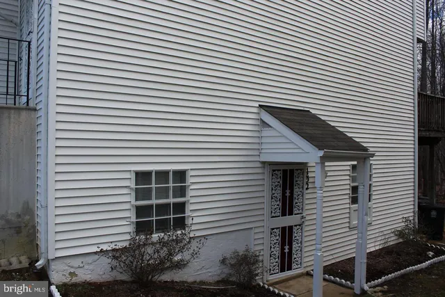 a front view of a house with plants