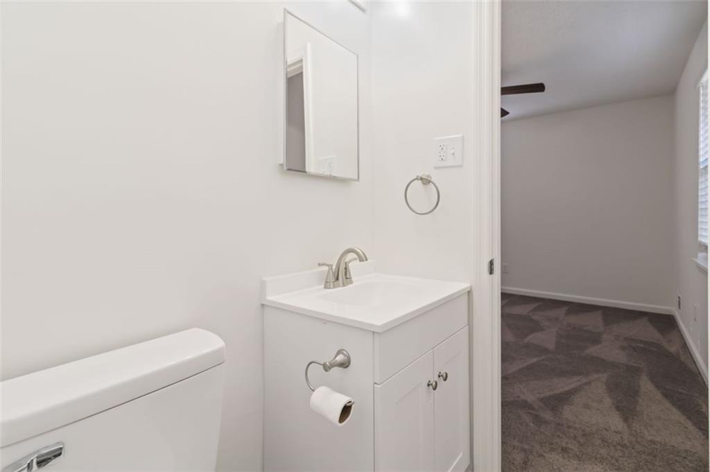 1535 Lake Jodeco Road Jonesboro, GA 30236 - Photo 23 of 45 a bathroom with a sink a toilet and mirror