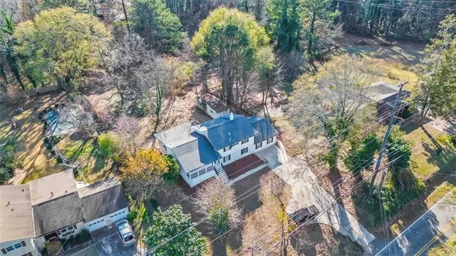 an aerial view of a house with a yard and garden