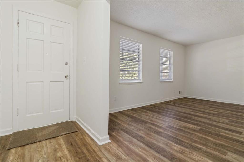 1535 Lake Jodeco Road Jonesboro, GA 30236 - Photo 6 of 45 a view of empty room with wooden floor and fan