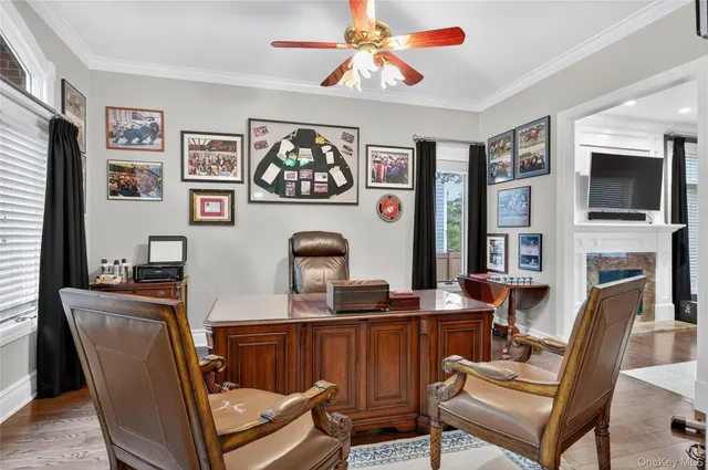 a view of a workspace with furniture and a flat screen tv