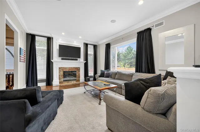 a living room with furniture fireplace and flat screen tv