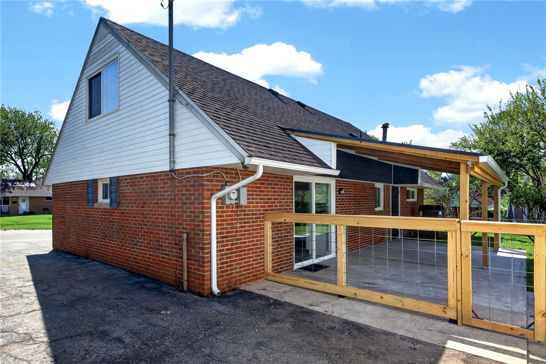 5975 Rosalie Road Dayton, OH 45424 - Photo 33 of 48 This house features a mix of classic brick and modern siding, with a spacious patio perfect for outdoor living.