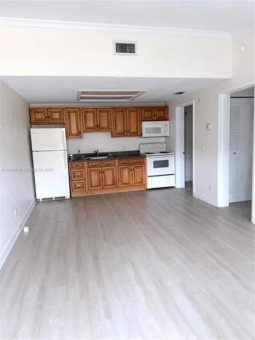 a view of kitchen and front door
