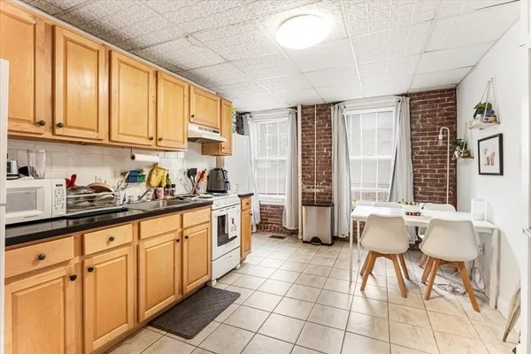 a kitchen with stainless steel appliances granite countertop a sink and cabinets