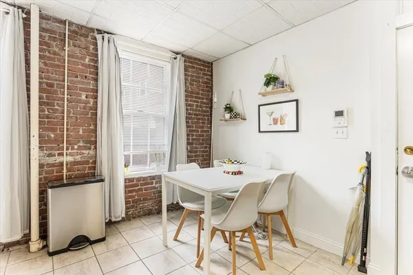 a view of a dining room with furniture and a window