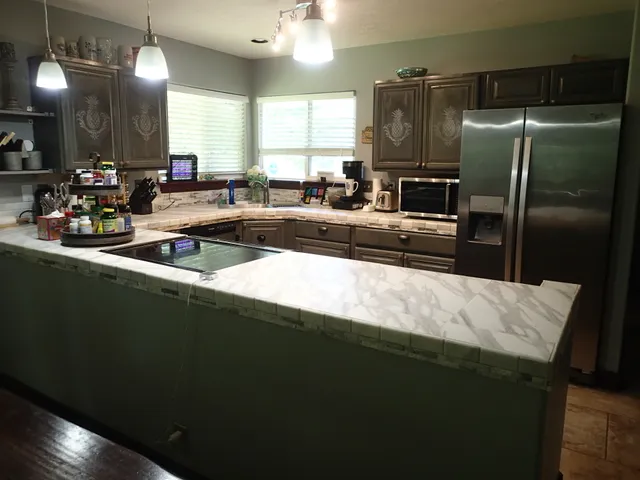 a kitchen with stainless steel appliances a sink stove and refrigerator