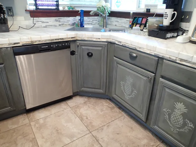 a kitchen with granite countertop a sink and a stove