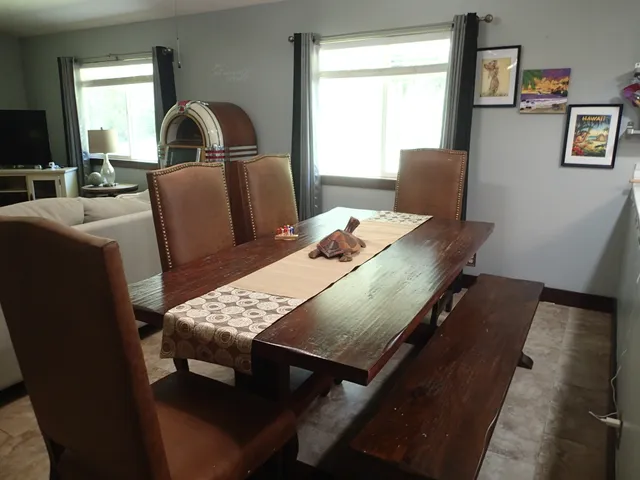 a view of a dining room with furniture and window