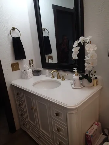 a bathroom with a sink and a mirror