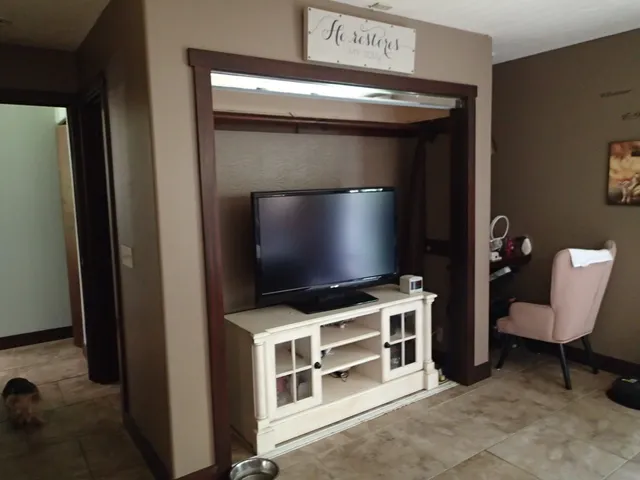 a living room with furniture and a flat screen tv