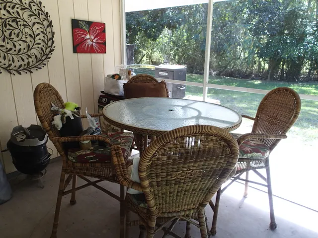 a view of a chairs and table in backyard