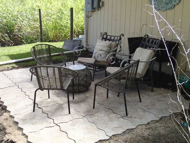 a backyard of a house with table and chairs