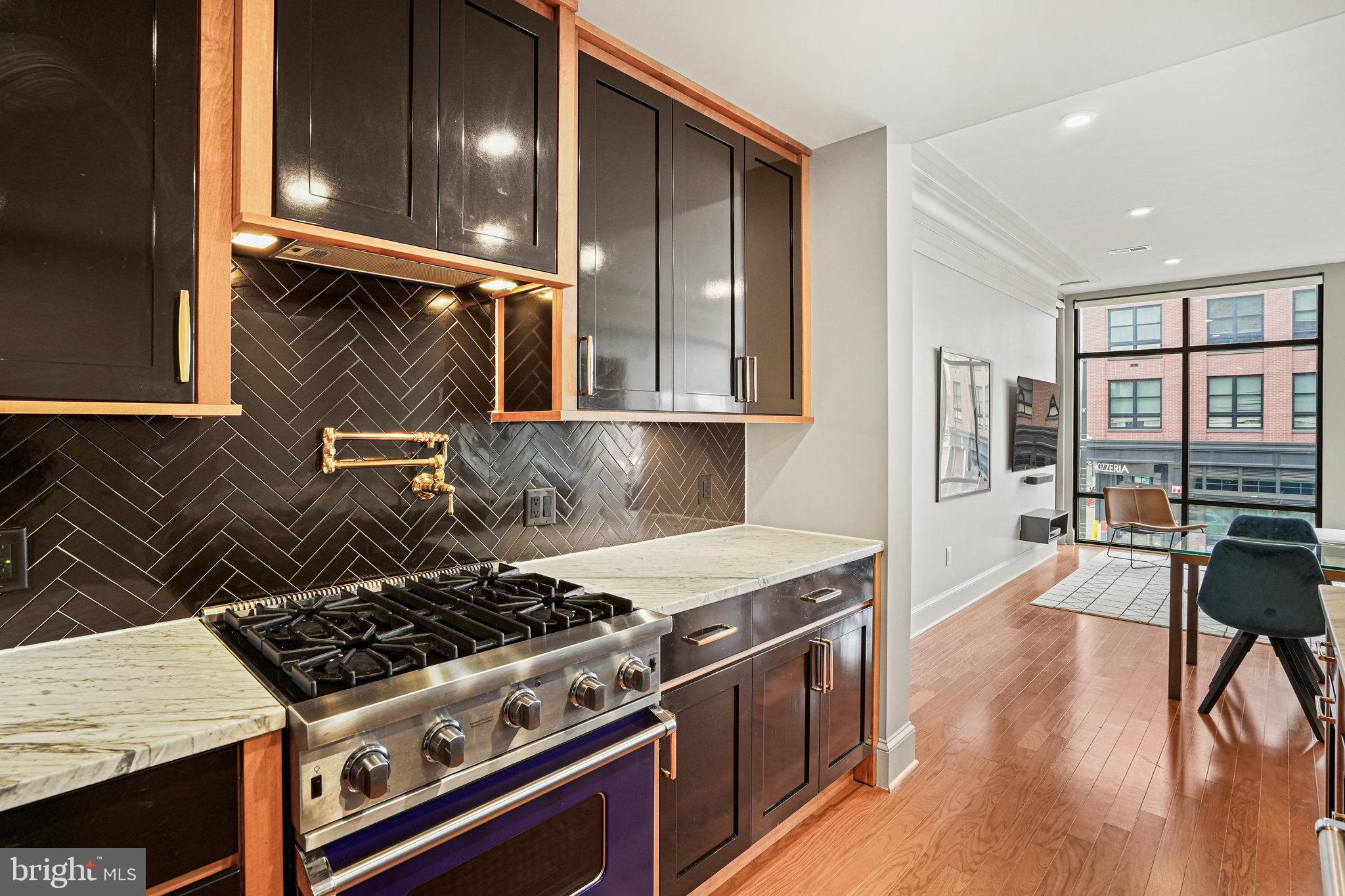 1301 H Street Northeast, Unit 1 Washington, DC 20002 - Photo 3 of 39 Viking 4-burner gas range and brass pot filler.