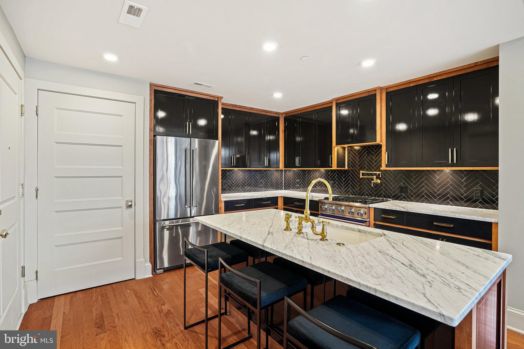 1301 H Street Northeast, Unit 1 Washington, DC 20002 - Photo 5 of 39 Cabinets lacquered/trimmed in honey toned maple.