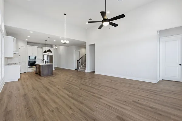 a view of a kitchen with a sink and wooden floor