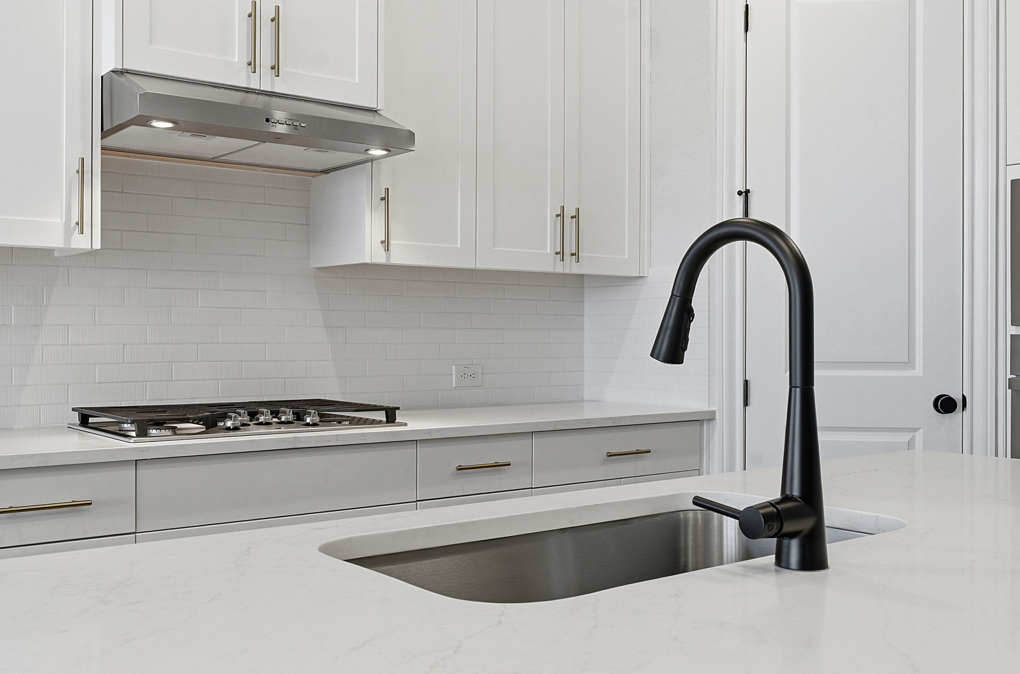 276 Prickly Poppy Loop Kyle, TX 78640 - Photo 19 of 38 Kitchen featuring white cabinetry, light stone countertops, and decorative backsplash