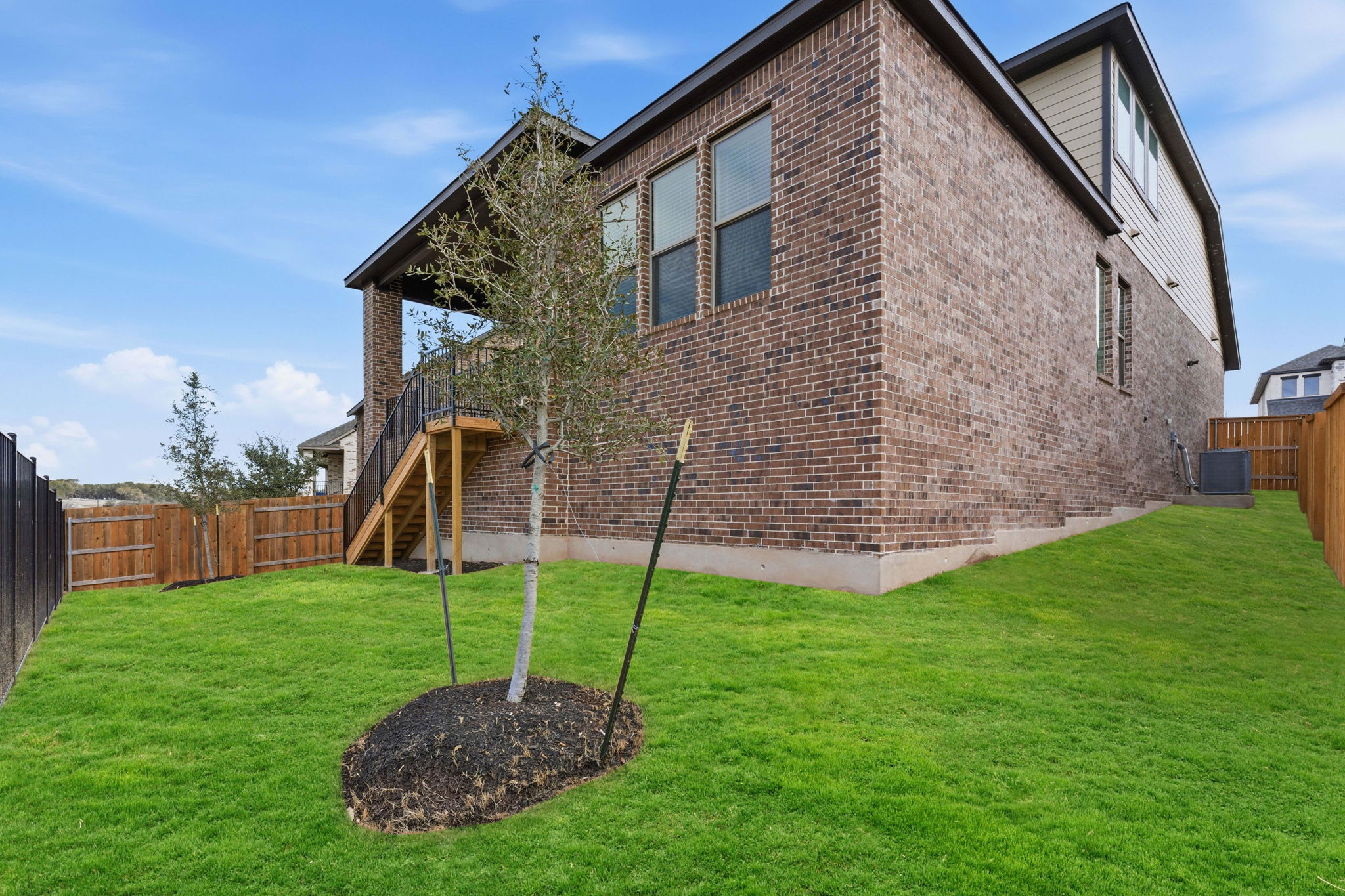 276 Prickly Poppy Loop Kyle, TX 78640 - Photo 2 of 38 Back of property featuring a fenced backyard and brick siding