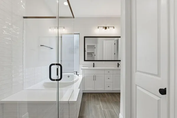 a bathroom with a shower a sink and a mirror