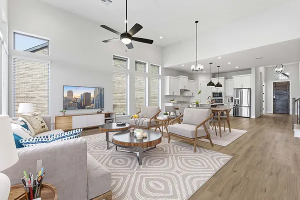 a living room with furniture wooden floor and a chandelier