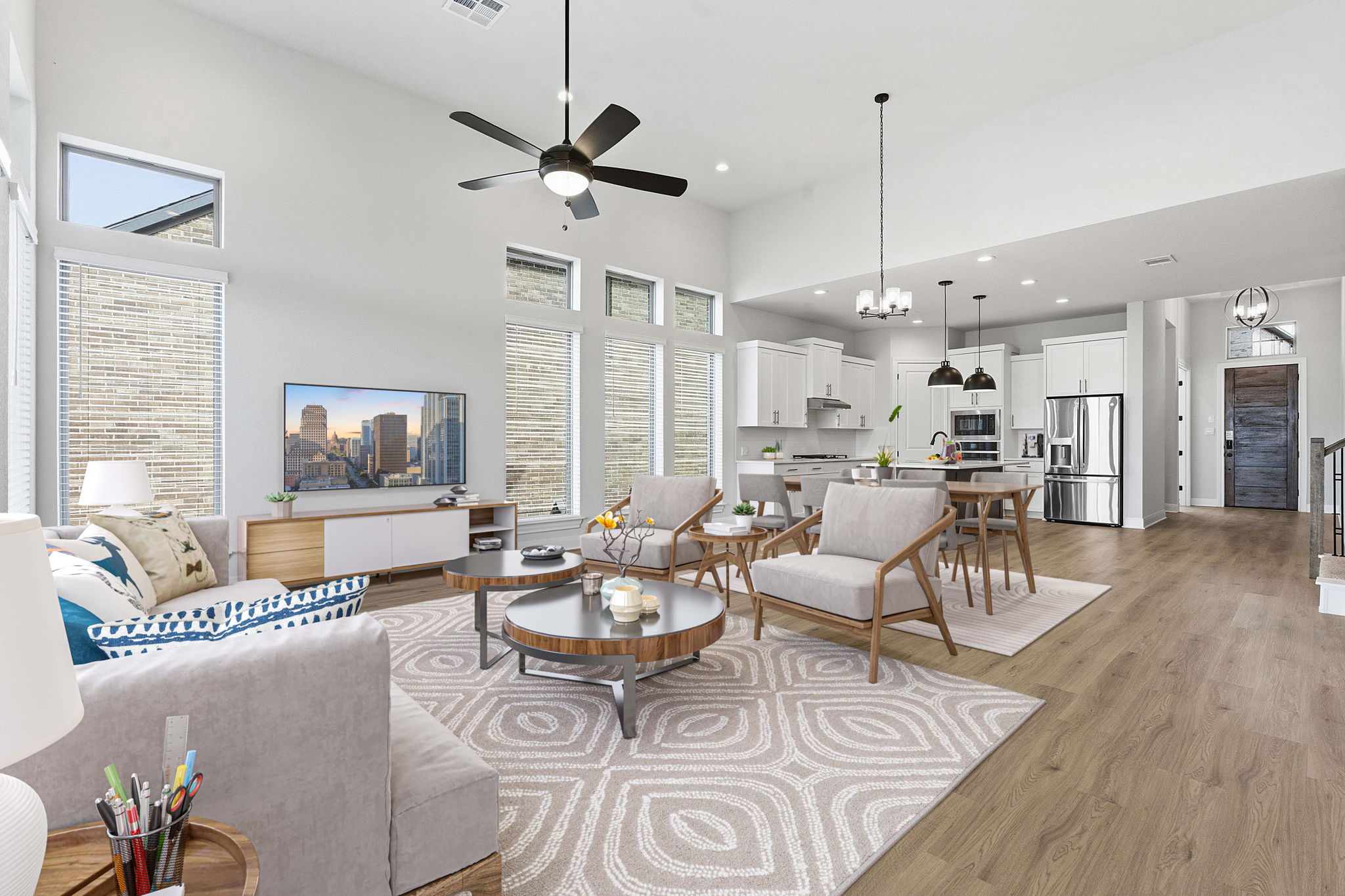 276 Prickly Poppy Loop Kyle, TX 78640 - Photo 4 of 38 Living area featuring a high ceiling, hanging lights, light wood-type flooring, a ceiling fan, and healthy amount of natural light