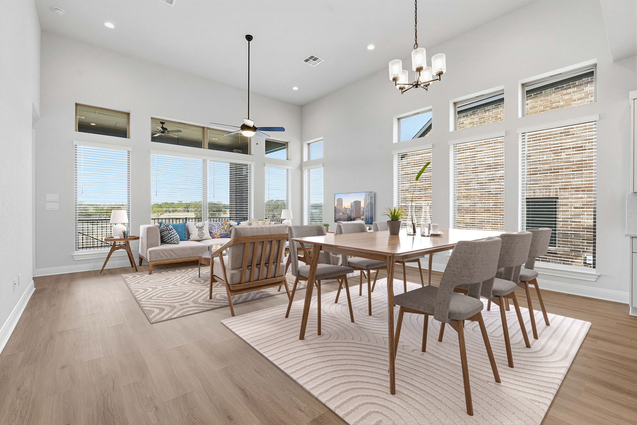 276 Prickly Poppy Loop Kyle, TX 78640 - Photo 5 of 38 Dining space with suspended lighting, a high ceiling, light wood-style floors, and ceiling fan