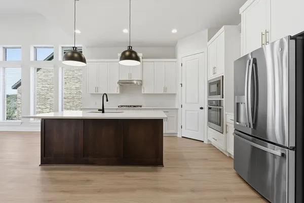 a kitchen with stainless steel appliances a refrigerator and a sink