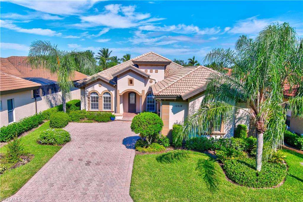 12518 Grandezza Circle Estero, FL 33928 - Photo 2 of 33 a aerial view of a house with a yard and potted plants
