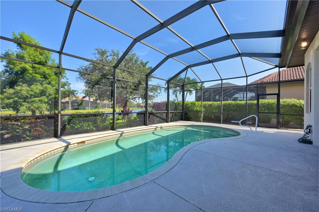 12518 Grandezza Circle Estero, FL 33928 - Photo 15 of 33 a view of a backyard with table and chairs under an umbrella