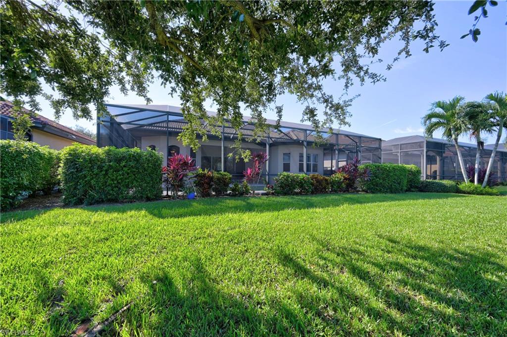 12518 Grandezza Circle Estero, FL 33928 - Photo 16 of 33 a view of a house with a backyard and a garden