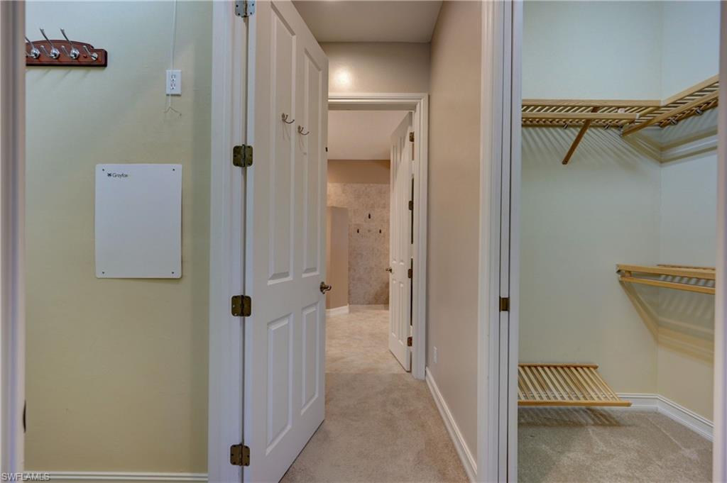 12518 Grandezza Circle Estero, FL 33928 - Photo 18 of 33 a view of a hallway with closet and wooden door