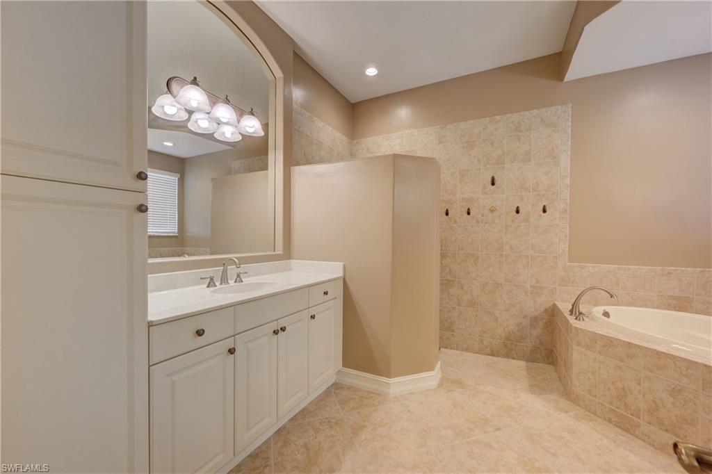 12518 Grandezza Circle Estero, FL 33928 - Photo 19 of 33 a bathroom with a double vanity sink mirror and bathtub
