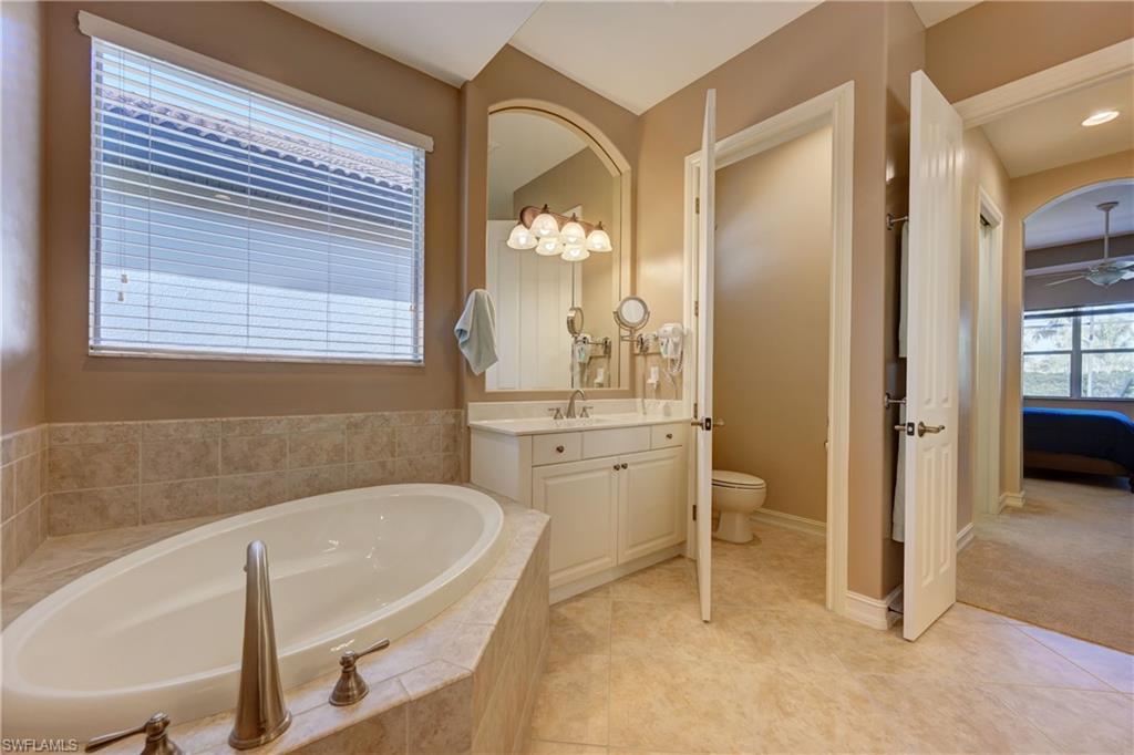 12518 Grandezza Circle Estero, FL 33928 - Photo 20 of 33 a bathroom with a tub sink and mirror