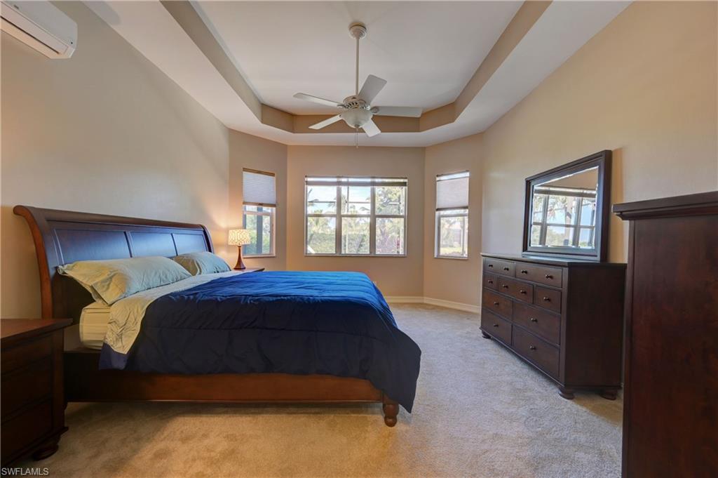 12518 Grandezza Circle Estero, FL 33928 - Photo 21 of 33 a bedroom with a large bed and a window