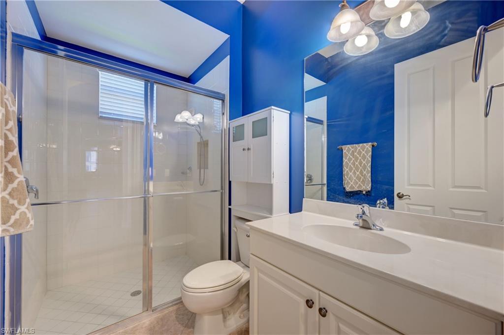 12518 Grandezza Circle Estero, FL 33928 - Photo 23 of 33 a bathroom with a sink a toilet and a large mirror