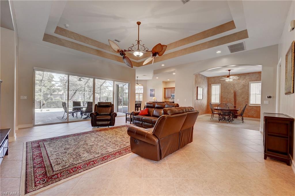 12518 Grandezza Circle Estero, FL 33928 - Photo 4 of 33 a living room with furniture ceiling fan and a large window