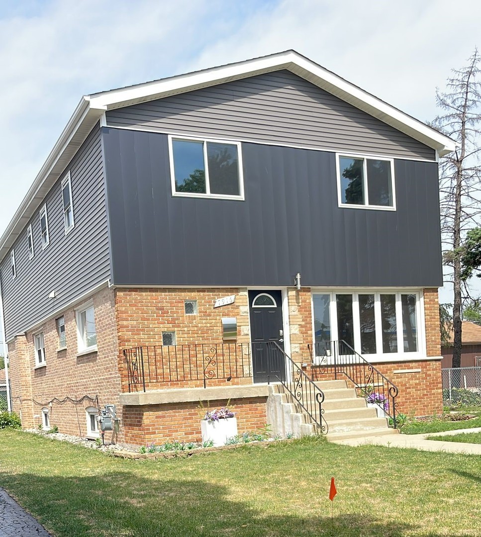 7916 McVicker Avenue Burbank, IL 60459 - Photo 1 of 19 a front view of a house with a yard