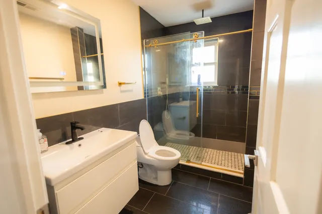 a bathroom with a sink toilet and shower
