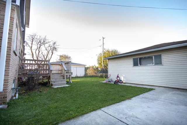 a front view of a house with a garden and yard