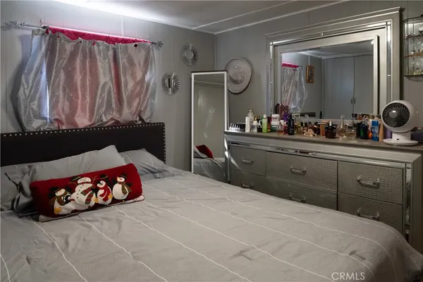 a bedroom with a large bed and a dresser