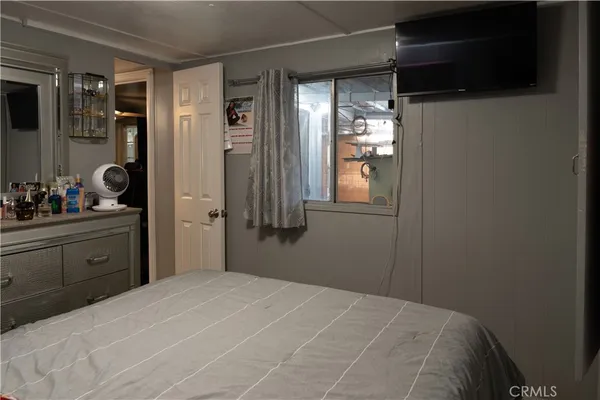 a bedroom with a bed and a dresser