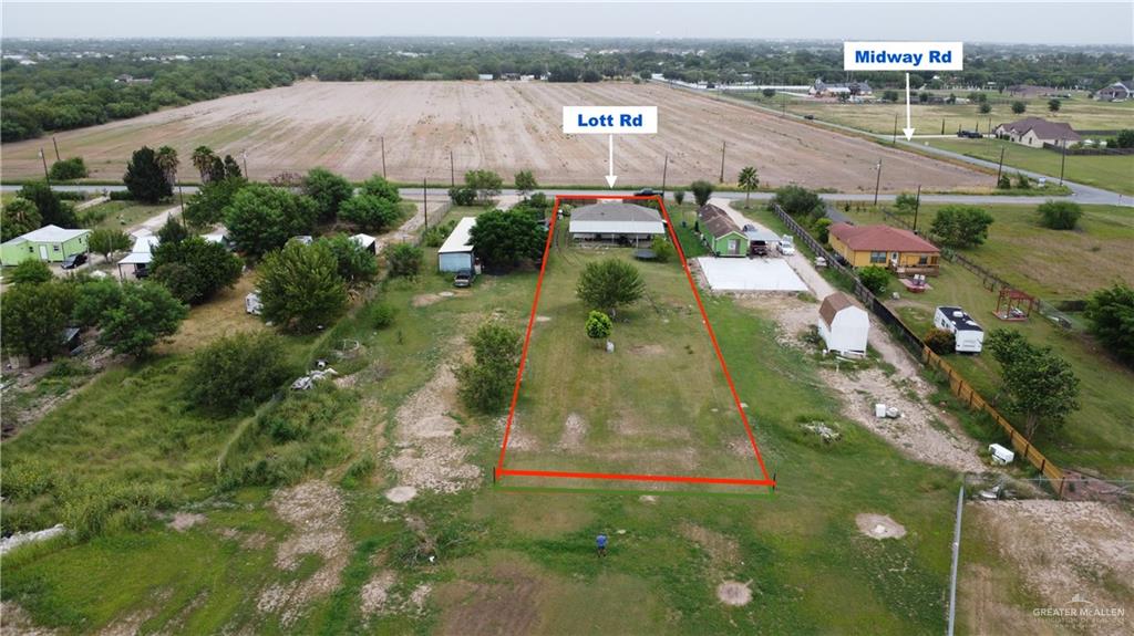 4204 Lott Road Donna, TX 78537 - Photo 27 of 28 Expansive land parcel featuring a main residence with a white roof, a detached white storage shed, and mature trees