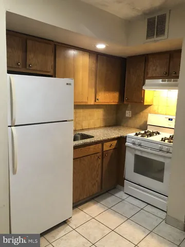 a kitchen with a refrigerator sink and stove