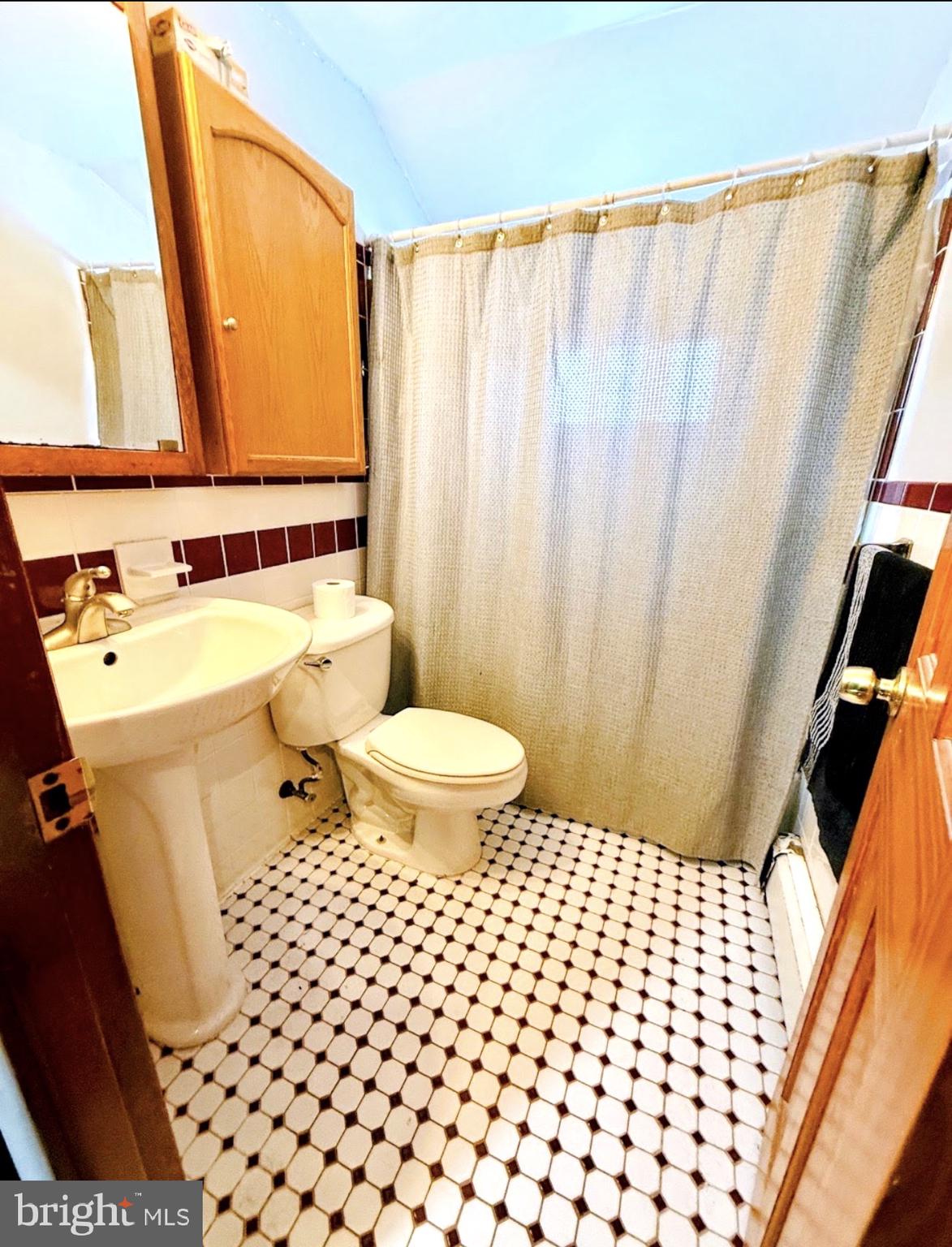 30 Misty Pine Road Levittown, PA 19056 - Photo 10 of 21 a bathroom with a sink a toilet a mirror and shower