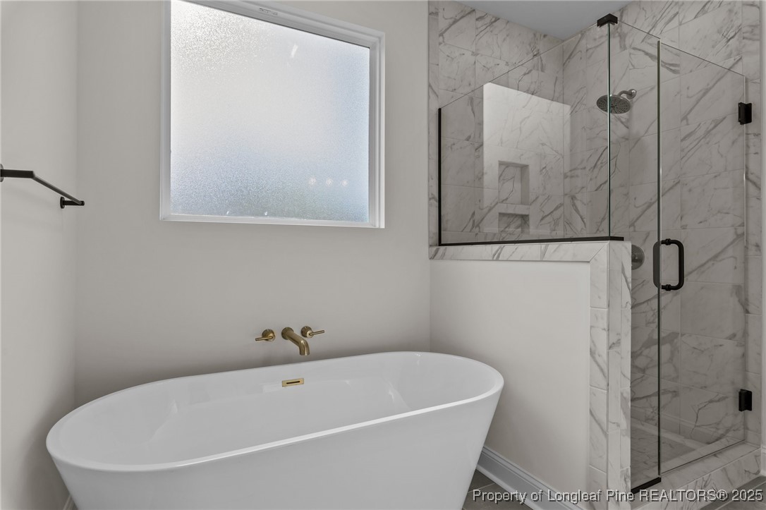 Tbd Doe Hill Road Autryville, NC 28318 - Photo 28 of 44 a white bath tub sitting next to a white sink and vanity