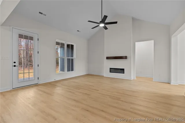 a kitchen with stainless steel appliances kitchen island wooden cabinets and a fireplace