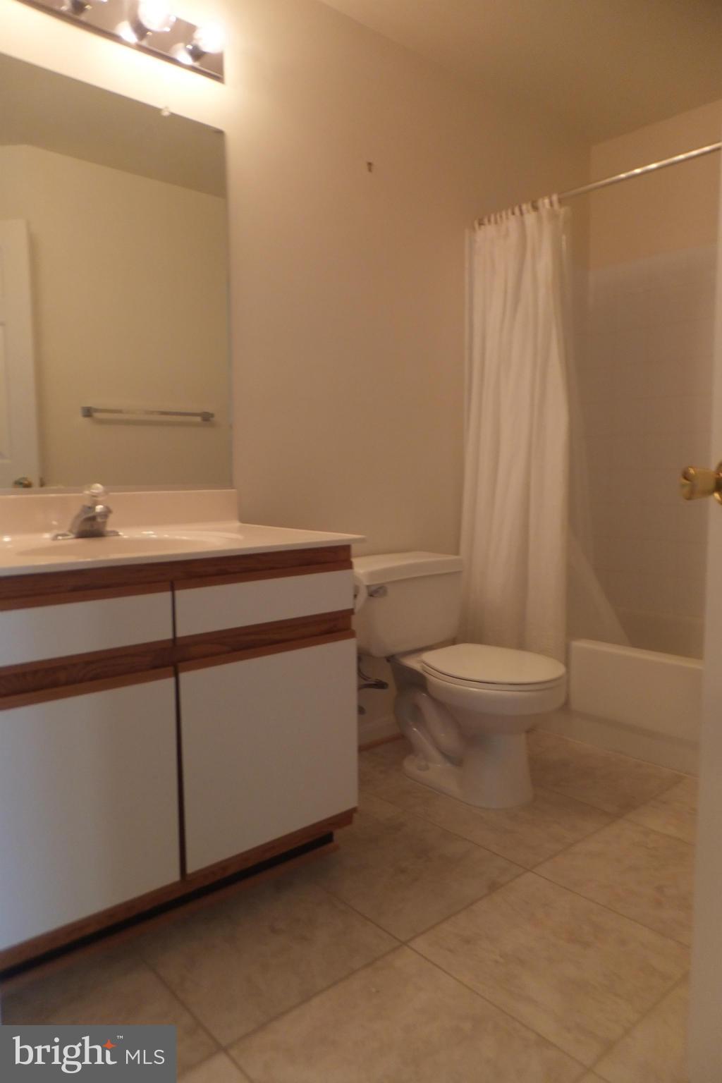 655 Constellation Square Southeast, Unit B Leesburg, VA 20175 - Photo 11 of 13 a bathroom with a sink a toilet and shower