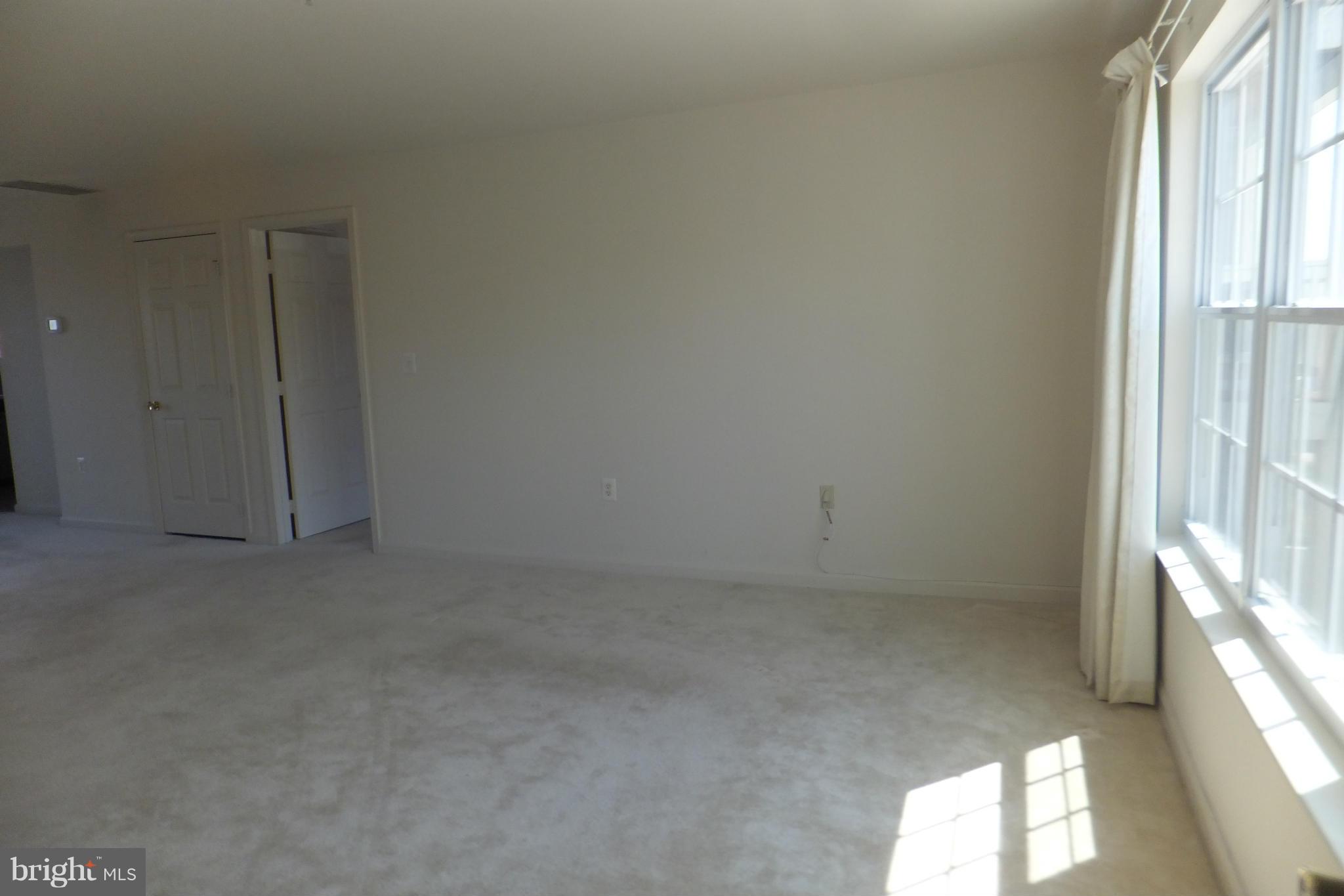 655 Constellation Square Southeast, Unit B Leesburg, VA 20175 - Photo 4 of 13 an empty room with windows