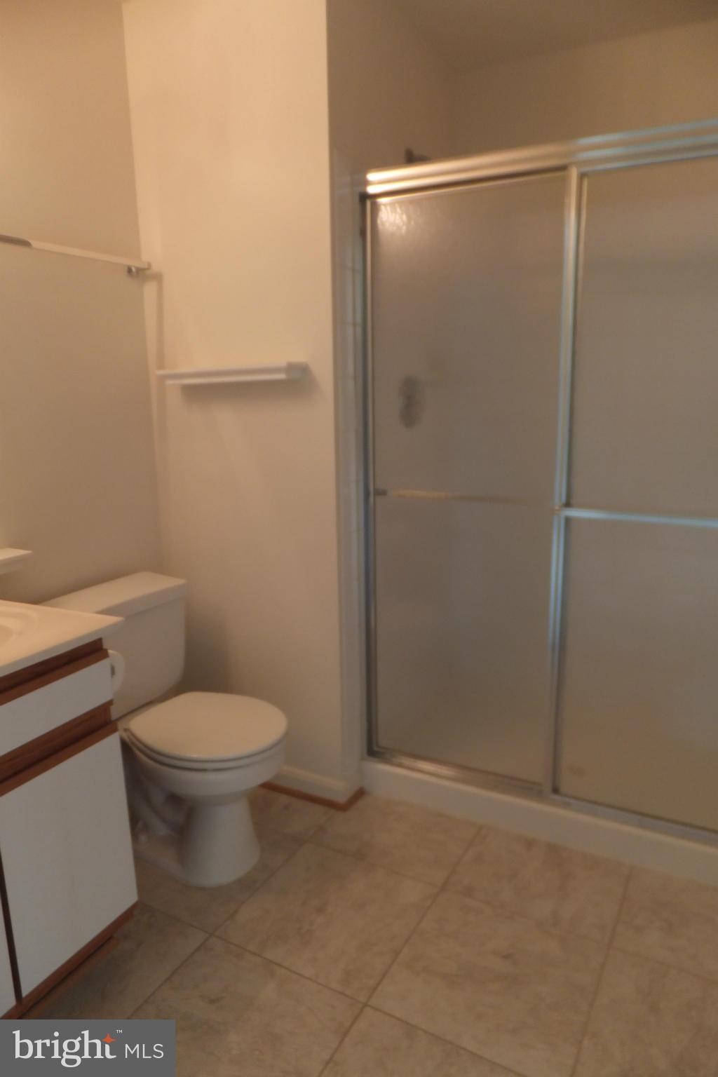 655 Constellation Square Southeast, Unit B Leesburg, VA 20175 - Photo 9 of 13 a bathroom with a toilet and a shower