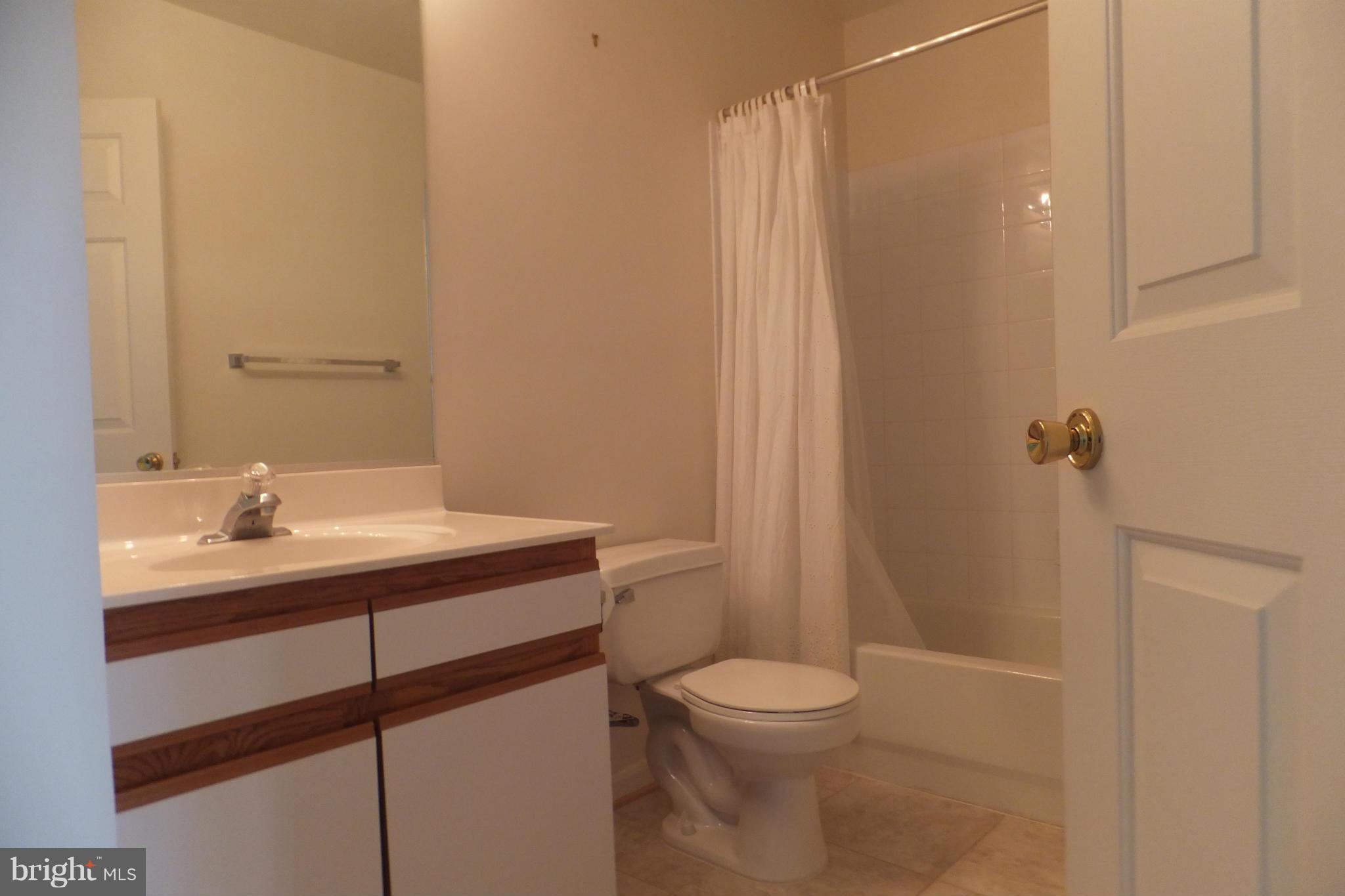 655 Constellation Square Southeast, Unit B Leesburg, VA 20175 - Photo 10 of 13 a bathroom with a sink a toilet and shower